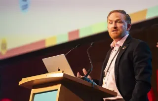 Dr Ronan Bree presenting at a podium
