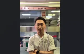 Eli Phuoc Le standing in the hotel kitchen