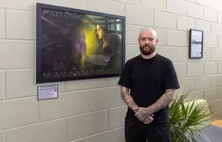Artist Ne O Nuallain with his painting "An Dochas Amach is an Aontas Isteach"