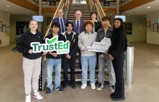 Dr. Brendan Ryder, Assistant Registrar, Dr Diarmuid O’Callaghan, President and Noreen Carney, Head of DkIT’s International Office with DkIT International students receiving the TrustEd Ireland international quality mark.