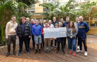 Students and lecturers from the Skills for Independent Living Course presenting their cheque