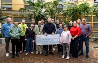Students on the Skills for Independent Living Course and their mentors present a cheque to John Kelly from Save Our Homeless, Dundalk 
