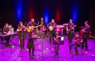 The DkIT Ceol Oirghialla Traditional Music Ensemble performing on stage.