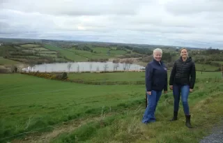 Mary O’Reilly, from the Kilsherdany Group Water Scheme Manager, County Cavan (left) and Kelsey Hammond, Research Assistant at DkIT and the Our Community, Our Water Co-ordinator (Right on the banks of Black Lough, Co Cavan)