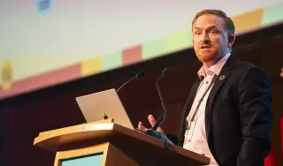 Dr Ronan Bree presenting at a podium