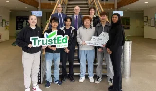 Dr. Brendan Ryder, Assistant Registrar, Dr Diarmuid O’Callaghan, President and Noreen Carney, Head of DkIT’s International Office with DkIT International students receiving the TrustEd Ireland international quality mark.