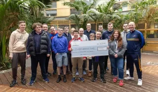 Students and lecturers from the Skills for Independent Living Course presenting their cheque