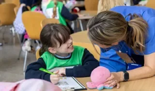 A student from St Patrick's NS Stamullen getting Teddy checked in for the Teddy Bear Hospital at DkIT