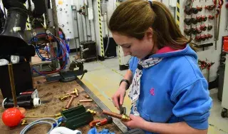 Guides in plumbing workshop connecting sections of pipe together