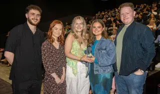 The crew of Reflection with the 2022 John Moore Film Award trophy - from L_R: Stephen Finlay, Wiktoria Rabiega, Jessica Doherty, Megan Hughes and Conor Leddy