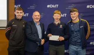 Player of The Tournament Sean Flynn being presented by David Rogers from Ganson