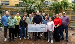 Students on the Skills for Independent Living Course and their mentors present a cheque to John Kelly from Save Our Homeless, Dundalk 