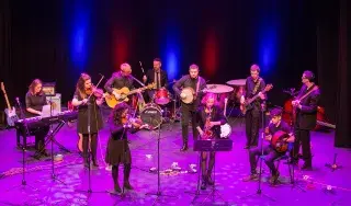 The DkIT Ceol Oirghialla Traditional Music Ensemble performing on stage.