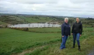 Mary O’Reilly, from the Kilsherdany Group Water Scheme Manager, County Cavan (left) and Kelsey Hammond, Research Assistant at DkIT and the Our Community, Our Water Co-ordinator (Right on the banks of Black Lough, Co Cavan)